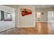 Hallway with hardwood floors provides a view of the spacious main bedroom and a bathroom, offering a glimpse of comfort and elegance at 2440 Ping Dr, Henderson, NV 89074
