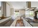 Spacious kitchen featuring stainless steel appliances, granite countertops, and wood floors at 2440 Ping Dr, Henderson, NV 89074