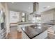 Bright kitchen with a gas cooktop island and stainless steel range hood at 2440 Ping Dr, Henderson, NV 89074