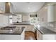 Modern kitchen featuring granite countertops, stainless steel appliances and stylish backsplash at 2440 Ping Dr, Henderson, NV 89074