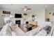 Bright living room with white fireplace, large TV, and view of the kitchen at 2440 Ping Dr, Henderson, NV 89074
