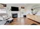 Cozy living room featuring a fireplace, hardwood floors, and natural light at 2440 Ping Dr, Henderson, NV 89074