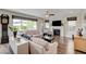Bright living room featuring hardwood floors, a fireplace, and large windows at 2440 Ping Dr, Henderson, NV 89074