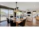 Open floorplan view from dining area to living room with fireplace and outdoor access at 2440 Ping Dr, Henderson, NV 89074