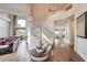 Elegant living room featuring a curved staircase, high ceilings, and wood-look flooring at 2440 Ping Dr, Henderson, NV 89074