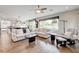 Spacious living room with hardwood floors, large windows, and comfortable seating at 2440 Ping Dr, Henderson, NV 89074
