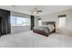 Large main bedroom with neutral carpet, a ceiling fan, and lots of natural light at 2440 Ping Dr, Henderson, NV 89074