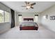 Large main bedroom with neutral carpet, a ceiling fan, and lots of natural light at 2440 Ping Dr, Henderson, NV 89074