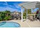 Charming patio area with pergola, perfect for outdoor dining and relaxation with lush landscaping at 2440 Ping Dr, Henderson, NV 89074