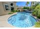 Inviting pool featuring clear blue water, a built-in spa, and tropical landscaping at 2440 Ping Dr, Henderson, NV 89074