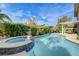 Beautiful pool with a spa, seating area, and meticulously landscaped backyard at 2440 Ping Dr, Henderson, NV 89074