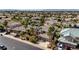 Street view of a home showcasing mature trees, a well-manicured lawn, and a three-car garage at 2440 Ping Dr, Henderson, NV 89074