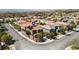 An aerial view showcases a two-story home with solar panels in a neighborhood with mountain views at 2529 Flodden St, Henderson, NV 89044
