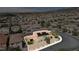 An aerial shot highlights a two-story home with a fenced backyard and solar panels, located in a residential neighborhood at 2529 Flodden St, Henderson, NV 89044