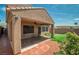 Covered patio and lush green lawn complemented by a well-maintained yard and surrounding landscape at 2529 Flodden St, Henderson, NV 89044
