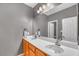 Bathroom with double sinks, wooden vanity, and a large framed mirror with vanity lighting at 2529 Flodden St, Henderson, NV 89044