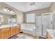 Bathroom features double vanity, soaking tub, and glass-enclosed shower at 2529 Flodden St, Henderson, NV 89044