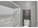 Bathroom featuring a shower with glass doors and tiled walls and a storage unit above the toilet at 2529 Flodden St, Henderson, NV 89044