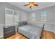 Bedroom with hardwood floors, ceiling fan, natural light, and neutral tones at 2529 Flodden St, Henderson, NV 89044