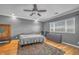 Comfortable bedroom features hardwood floors, a ceiling fan, and views from the large window at 2529 Flodden St, Henderson, NV 89044