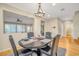 Inviting dining area with hardwood floors, a chandelier, and views into the living space at 2529 Flodden St, Henderson, NV 89044