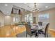 Inviting dining area with hardwood floors, a chandelier, and views into the living space at 2529 Flodden St, Henderson, NV 89044