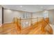 Spacious upstairs hallway with hardwood floors, wood banister, and ample natural light at 2529 Flodden St, Henderson, NV 89044