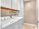 The laundry room features a full size washer and dryer with storage cabinets and shelving at 2529 Flodden St, Henderson, NV 89044