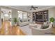 Staged living room features hardwood floors, neutral tones, a ceiling fan, and a built-in entertainment center at 2529 Flodden St, Henderson, NV 89044