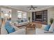 Staged living room features hardwood floors, neutral tones, a ceiling fan, and a built-in entertainment center at 2529 Flodden St, Henderson, NV 89044