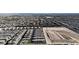 Wide aerial view of a dense residential area and the surrounding community, and construction area at 2598 Polar White Ave, North Las Vegas, NV 89086