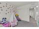 Charming room with flower wall decals, decorative teepee, and ample playing space at 2598 Polar White Ave, North Las Vegas, NV 89086