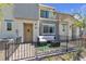 Charming townhouse with a cozy, fenced front patio seating area and a modern, neutral color scheme at 2598 Polar White Ave, North Las Vegas, NV 89086