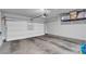 Spacious garage with white door, storage shelves, and ample room for parking and projects at 2598 Polar White Ave, North Las Vegas, NV 89086