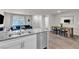 Open concept kitchen with stainless steel appliances, hardwood floors and dining area at 2598 Polar White Ave, North Las Vegas, NV 89086