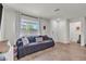 Bright and airy living room featuring hardwood floors, a large window, and modern decor at 2598 Polar White Ave, North Las Vegas, NV 89086
