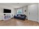 Bright living room with hardwood floors, large window and a cozy couch with throw pillows at 2598 Polar White Ave, North Las Vegas, NV 89086