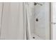 This walk-in shower features marble tiling, a shower curtain, and brushed nickel hardware at 2598 Polar White Ave, North Las Vegas, NV 89086