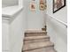 Carpeted staircase with white handrail leading to the next level, accented with framed wall decor at 2598 Polar White Ave, North Las Vegas, NV 89086