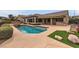 Backyard showcasing pool, turf, and lush landscaping, perfect for entertaining at 2784 Cherrydale Falls Dr, Henderson, NV 89052