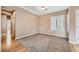 Carpeted bedroom featuring neutral walls, window with blinds and hardwood flooring outside entry at 2784 Cherrydale Falls Dr, Henderson, NV 89052