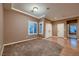 Cozy bedroom featuring a large window with shutter blinds and direct access to the hallway at 2784 Cherrydale Falls Dr, Henderson, NV 89052