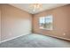 This bedroom features neutral walls, carpet, a ceiling fan, and views from the window at 2784 Cherrydale Falls Dr, Henderson, NV 89052