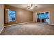 Neutral bedroom featuring carpet, ceiling fan and sliding glass doors with access to outdoor living space at 2784 Cherrydale Falls Dr, Henderson, NV 89052
