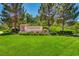 Well-manicured Anthem Center entrance sign surrounded by lush green lawn and mature trees at 2784 Cherrydale Falls Dr, Henderson, NV 89052