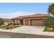 Traditional-style home featuring a tile roof, stone veneer, and well-maintained landscaping at 2784 Cherrydale Falls Dr, Henderson, NV 89052