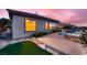Beautiful backyard with a sparkling pool, hot tub, and putting green at 2784 Cherrydale Falls Dr, Henderson, NV 89052
