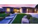 Inviting home exterior featuring stone accents, an arched entry and lush, manicured landscaping at 2784 Cherrydale Falls Dr, Henderson, NV 89052