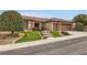 Charming home showcasing a well-manicured front yard with artificial turf and desert landscaping at 2784 Cherrydale Falls Dr, Henderson, NV 89052