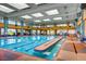 Indoor pool featuring a full sized pool, many windows, and a lounge area for residents at 2784 Cherrydale Falls Dr, Henderson, NV 89052